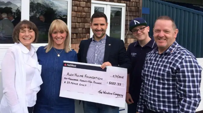 The Window Company owner, Wayne Shaw, with Alex's parents. Above: Staff hand over the cheque