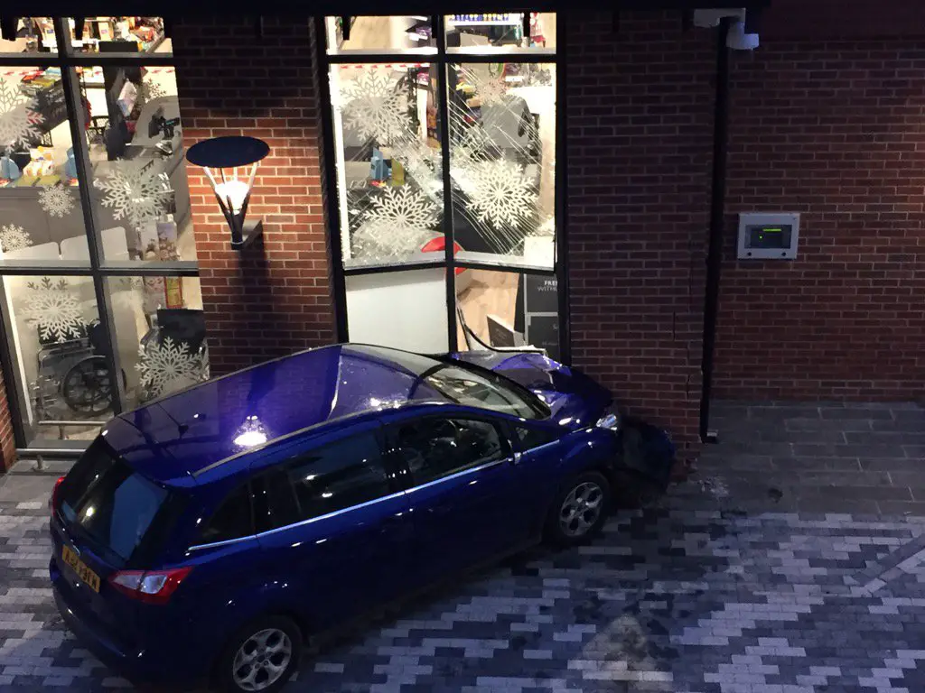 The blue Ford embedded in the supermarket