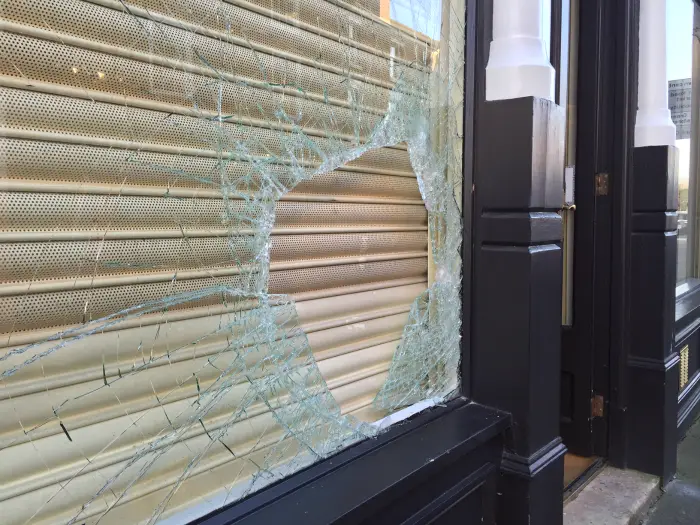 The damaged window at Elite Dress Agency this morning