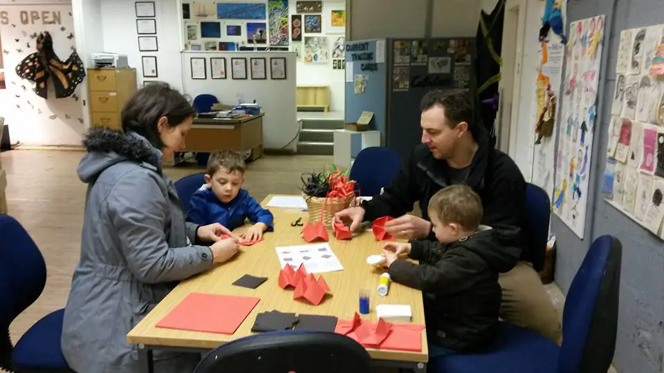 A family getting involved in craft activities at Art With a Heart