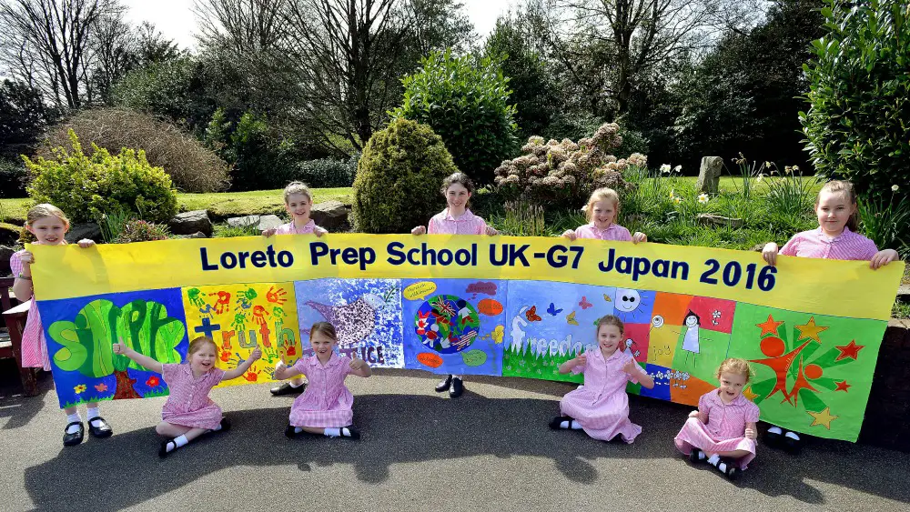 Pictured (l to r): Elsie Parkinson, Honor Charnley, Ellie Jaberi and Isla Cartwright, and holding the banner are Aine Pegler, India Palin, Eva Galais, Grace George and Phoebe Prigmore