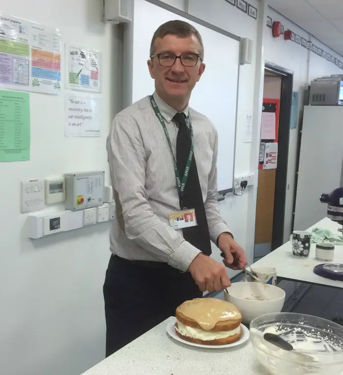 Altrincham Grammar teacher Mr Hall with one of the baked cakes