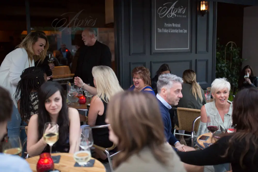 Customers enjoying their drinks outside Après Wine Bar on Shaw's Road