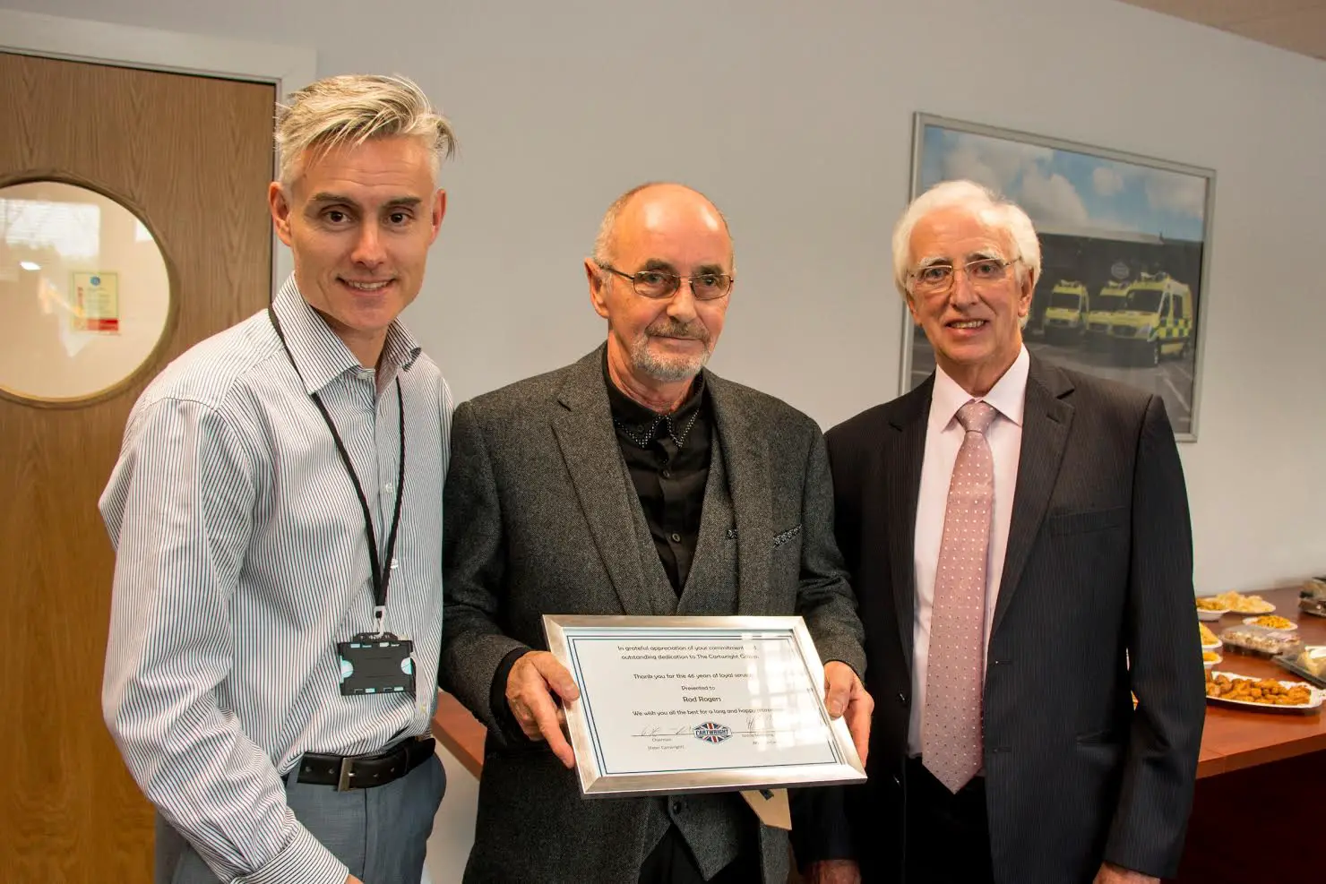 Rob Rogers (centre) receives his retirement certificate from Cartwright group MD Mark Cartwright (left) and chairman Peter Cartwright 