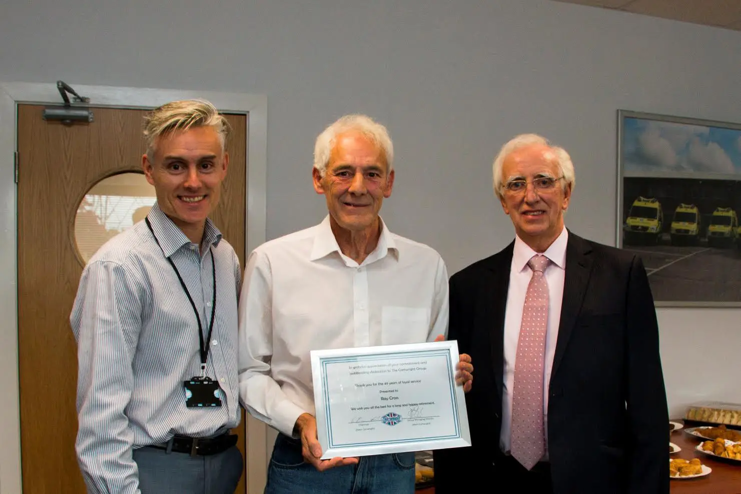 Ray Cross (centre) receives his retirement certificate from Cartwright group MD Mark Cartwright (left) and chairman Peter Cartwright