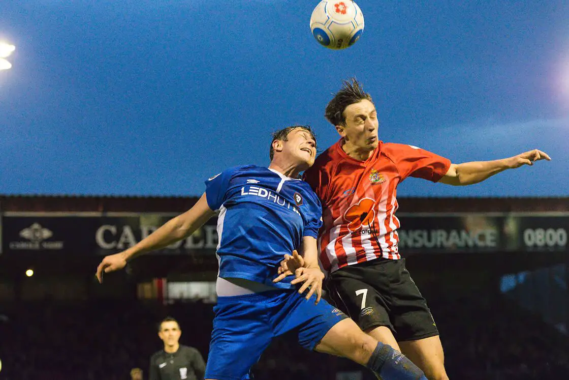 Greg Wilkinson beats a Salford player to a header