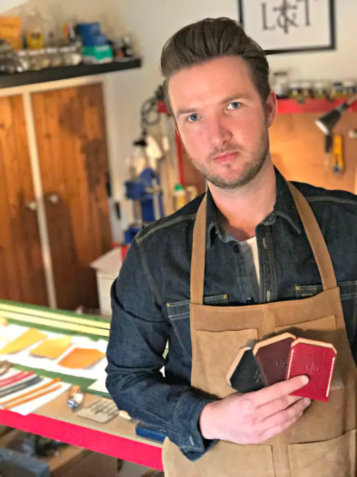 Simon with three of his signature two-pocket wallets