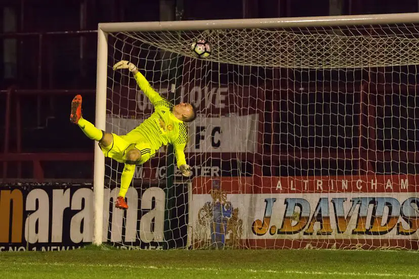 The Man U goalkeeper flaps at the ball as Alty score