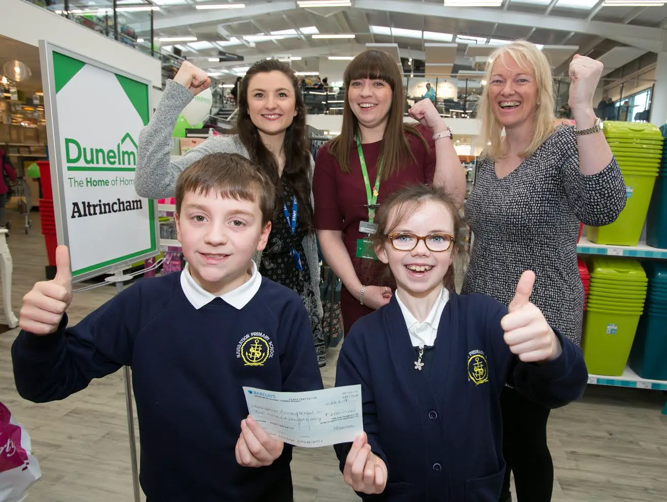 Navigation Primary School pupils are presented with a cheque for £200 by Dunelm earlier today