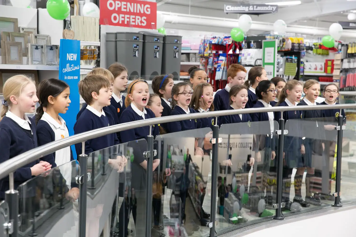 Navigation Primary School pupils sing at the shop's opening this morning