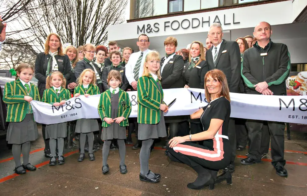 Store manager Liz Rushton will pupils from Hale Prep at the opening of the new M&S Food Hall today